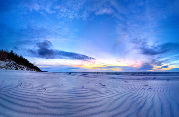 Baltic Sea and beautiful sunset on the beach in Slowinski National Park near Leba, Poland. Wild,...