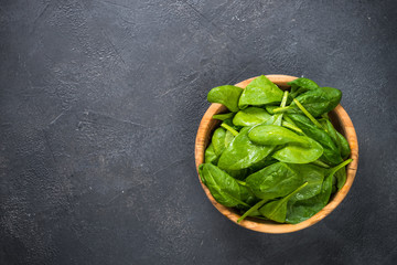 Baby spinach leaves on black background.