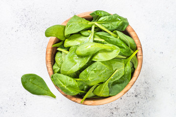 Baby spinach leaves on white background.