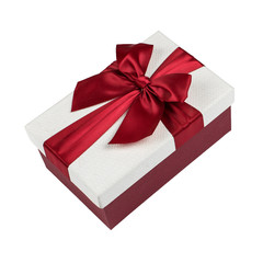 Gift with a red ribbon and a bow on a white background, isolate, copy space.