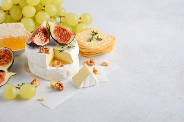 Brie or camembert cheese with figs, grapes, honey and nuts.