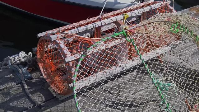 Close of a fishermen's lobster or crab pot in Lysekil, Sweden. Slow handheld pan around from left to right