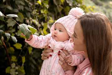 Cute young mother with her little baby girl