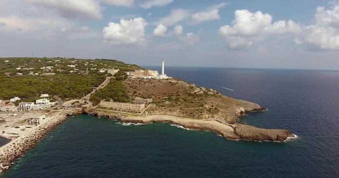 White lighthouse of Santa Maria di Leuca on the hilltop near sea port, Apulia, Salento region of southern Italy, on a sunny summer day .