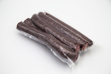 Deer home sausage is packed in a vacuum for winter on a white background.