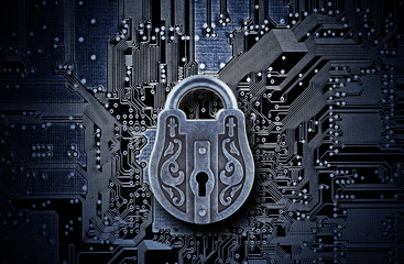 Computer security concept. Old mysterious padlock on computer circuit board 