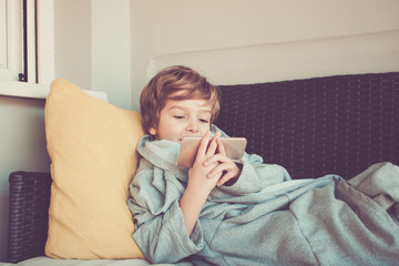 Smiling little boy using smart phone while enjoying on a terrace.