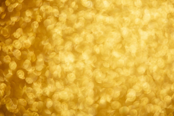 Gold glittering christmas lights. Blurred abstract background.