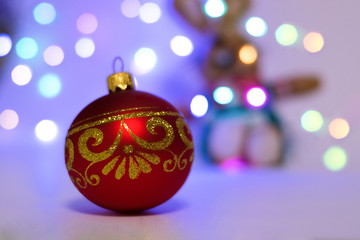 Fototapeta premium Red Christmas toy and lights. Christmas mood. New Year's Holidays.