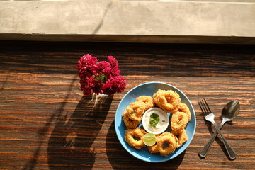 crispy calamari rings from top view on wood table