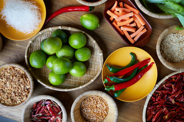 Top view background of various Oriental spices and food ingredients set on wooden table in kitchen, copy space