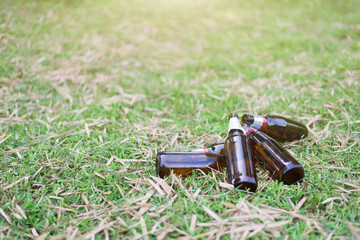 Glass bottles piled on the lawn, Focus on bottle, Environmental concept. Close-up.