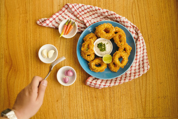 crispy calamari rings from top view on wood table