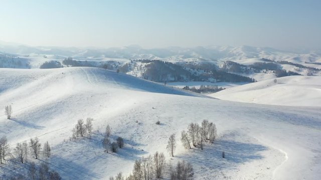 Aerial video view from drone on winter snow landscape natural background. Altai, Siberia, Russia