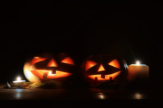 holidays image of halloween. Pumpkins over wooden table dark background
