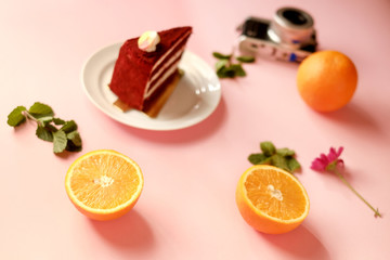 orange fruit top view with cake on pink background.