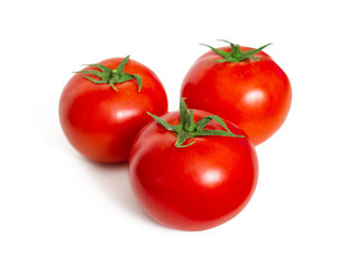 Red fresh tomatoes with cuttings on white background