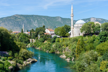 view of the Neretva river and the stone bridge with the promenade