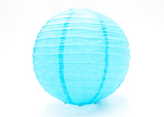 One Japanese style handmade round blue paper lantern closeup isolated on white background