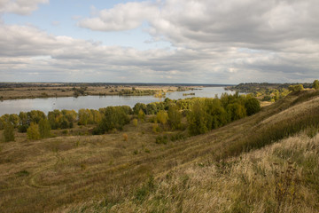 Naklejka premium Autumn panoramic landscape with river and hills cloudy day in Konstantinovo village Russia
