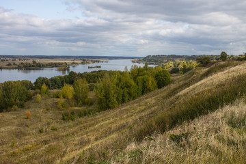 Obraz premium Autumn panoramic landscape with river and hills cloudy day in Konstantinovo village Russia