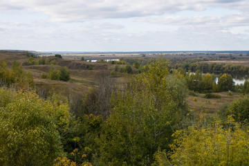 Naklejka premium Autumn panoramic landscape with river and hills cloudy day in Konstantinovo village Russia