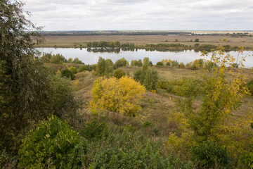 Autumn panoramic landscape with river and hills cloudy day in Konstantinovo village Russia