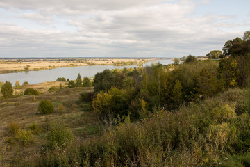 Autumn panoramic landscape with river and hills cloudy day in Konstantinovo village Russia