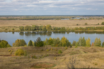 Autumn panoramic landscape with river and hills cloudy day in Konstantinovo village Russia