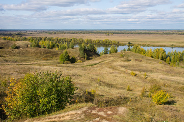 Autumn panoramic landscape with river and hills cloudy day in Konstantinovo village Russia