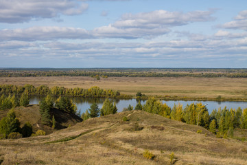 Autumn panoramic landscape with river and hills cloudy day in Konstantinovo village Russia