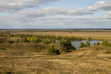 Fototapeta premium Autumn panoramic landscape with river and hills cloudy day in Konstantinovo village Russia