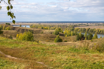 Autumn panoramic landscape with river and hills cloudy day in Konstantinovo village Russia