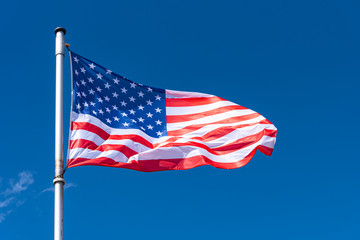 USA Flag and blue Sky as Background, American Flag waving on flagpole, New York