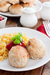 Homemade turkey cutlets with cheese filling on a white plate, selective focus