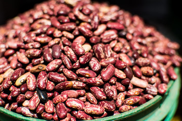 Bowl of red beans, piled up, in close-up and detail, with defocused background