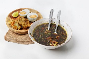 traditional indonesia food rawon with eggs from top view.