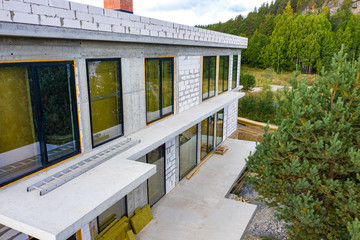 Construction of country houses. A two-storey building of white stone is being built. Construction...