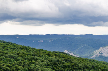Mountains covered with forests before the rain.