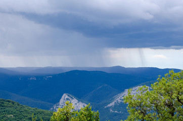 Obraz premium Mountains covered with forests before the rain.