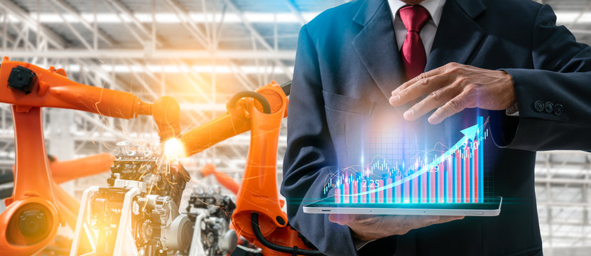 Robotics or digital intelligent manufacturing operation concept.Manager engineer control and check automation robot machine in intelligent factory.Supervisor management on real time monitoring system.