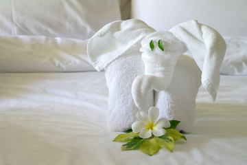 White spa towel twisted in the form of an elephant close-up, looking at you