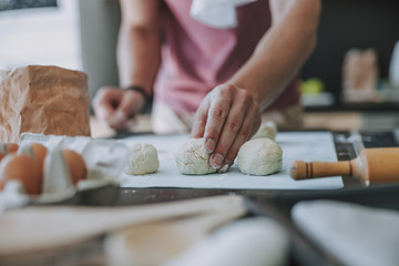 Obraz na płótnie Canvas Cook shaping the dough preparing his breakfast