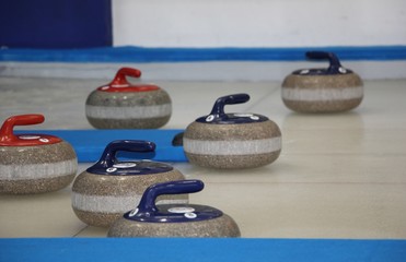 Curling stones equipment on the ice