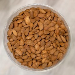 Almonds in a bowl with soft background.