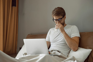 Man having cold spending time in his bed