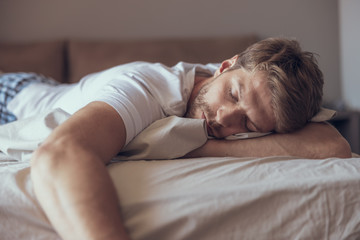 Handsome man falling asleep in the morning