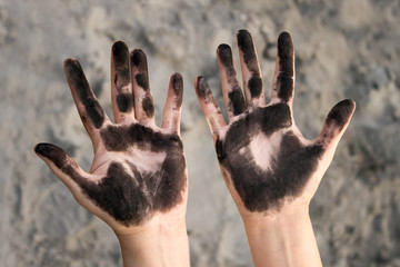 dirty hands stained with something black
