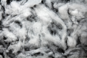 Siliconized hollowfiber, polyester fiber on a black background, used as a filler for blankets,...