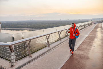 Handsome young male walking on a footbridge